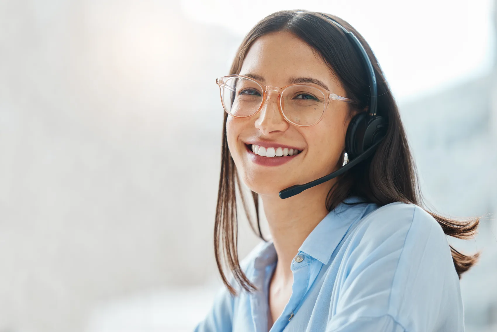 A GoStaffer support agent smiling on a call